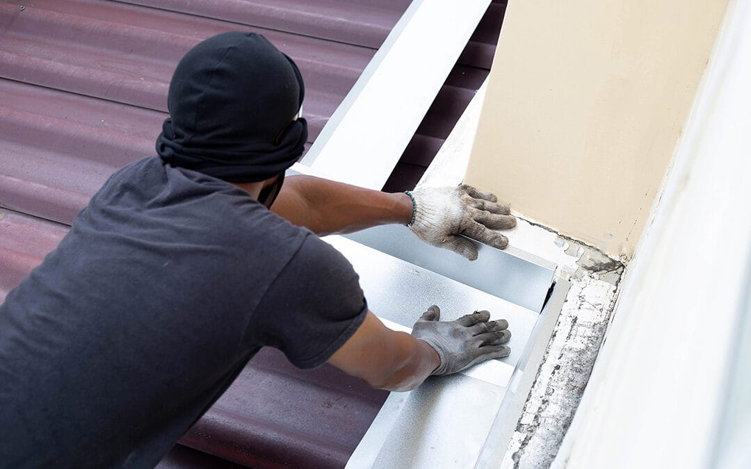 Roof repair, Worker with steel sheet. Stop a roof leak