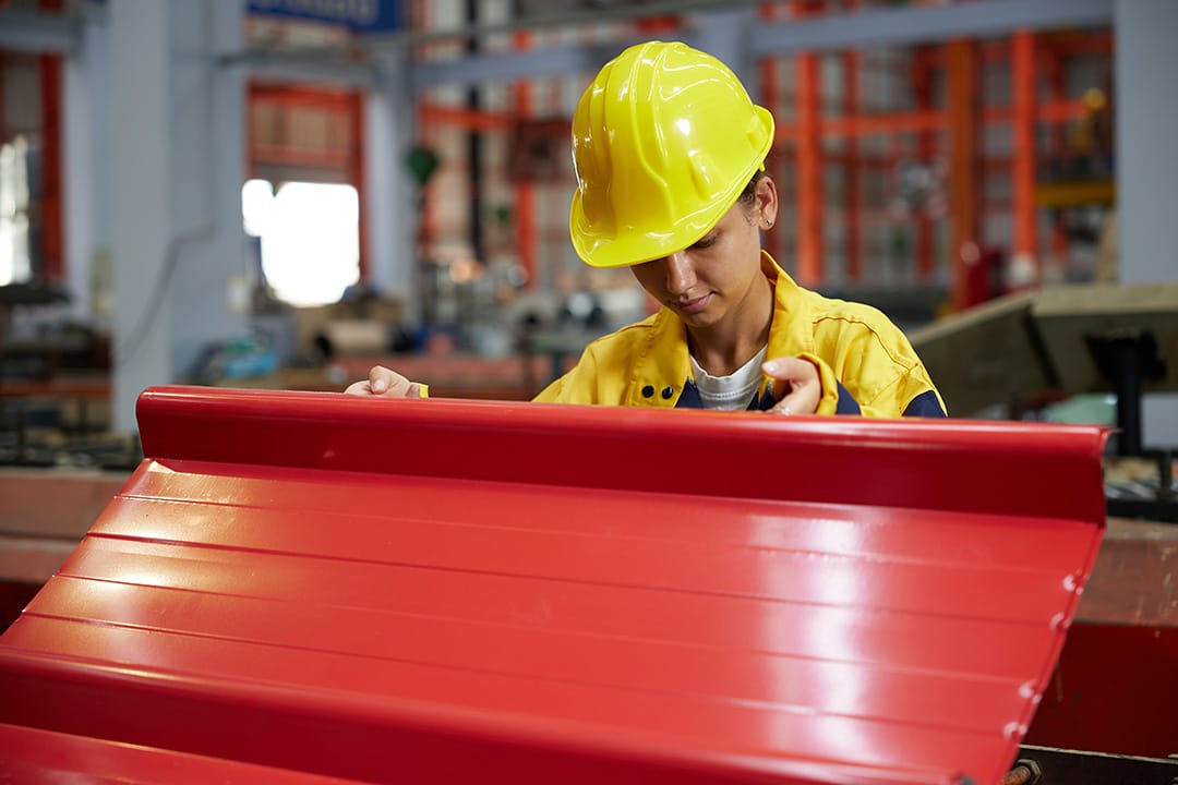 worker or technician holding and checking quality metal sheet in the factory