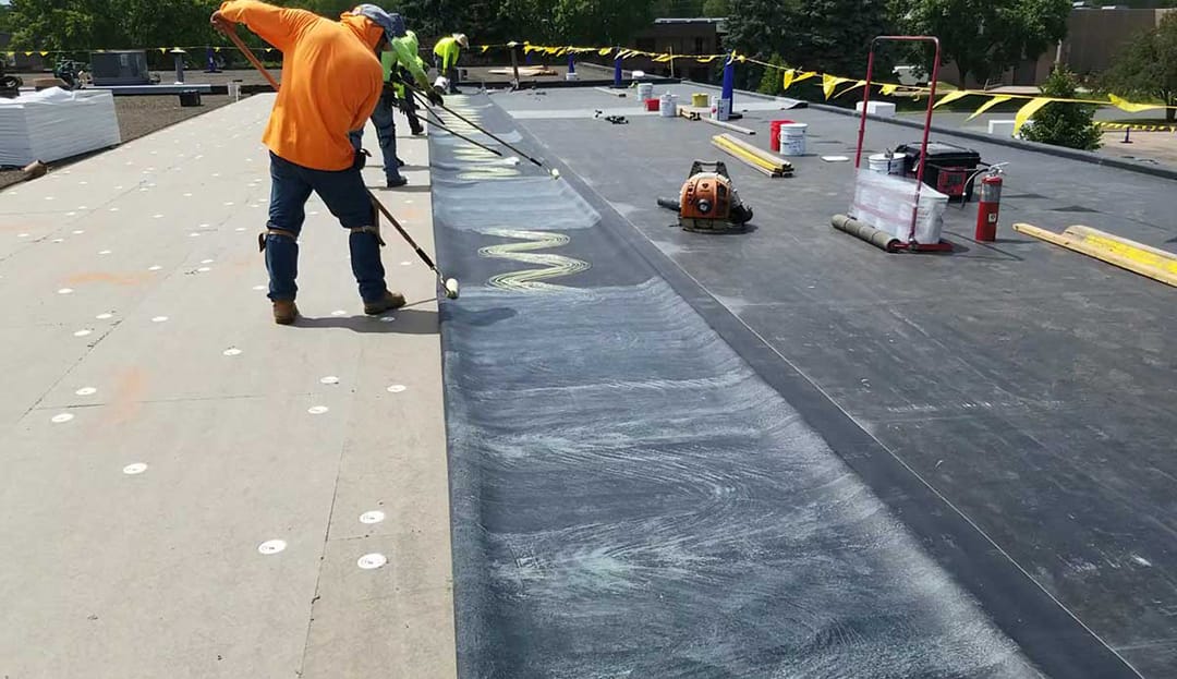 Construction worker wearing PPE woking at roof