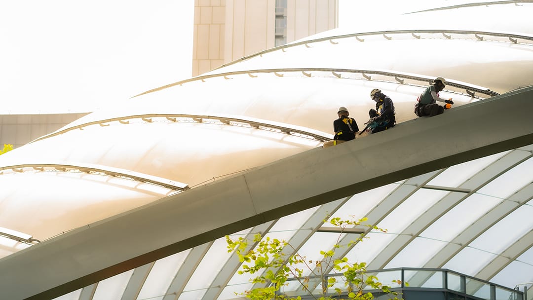 Team of technician roof repair and cleaning service on commercial roof