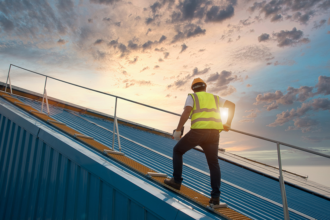 Steel roof structure construction Construction worker wlak on roof for inspection