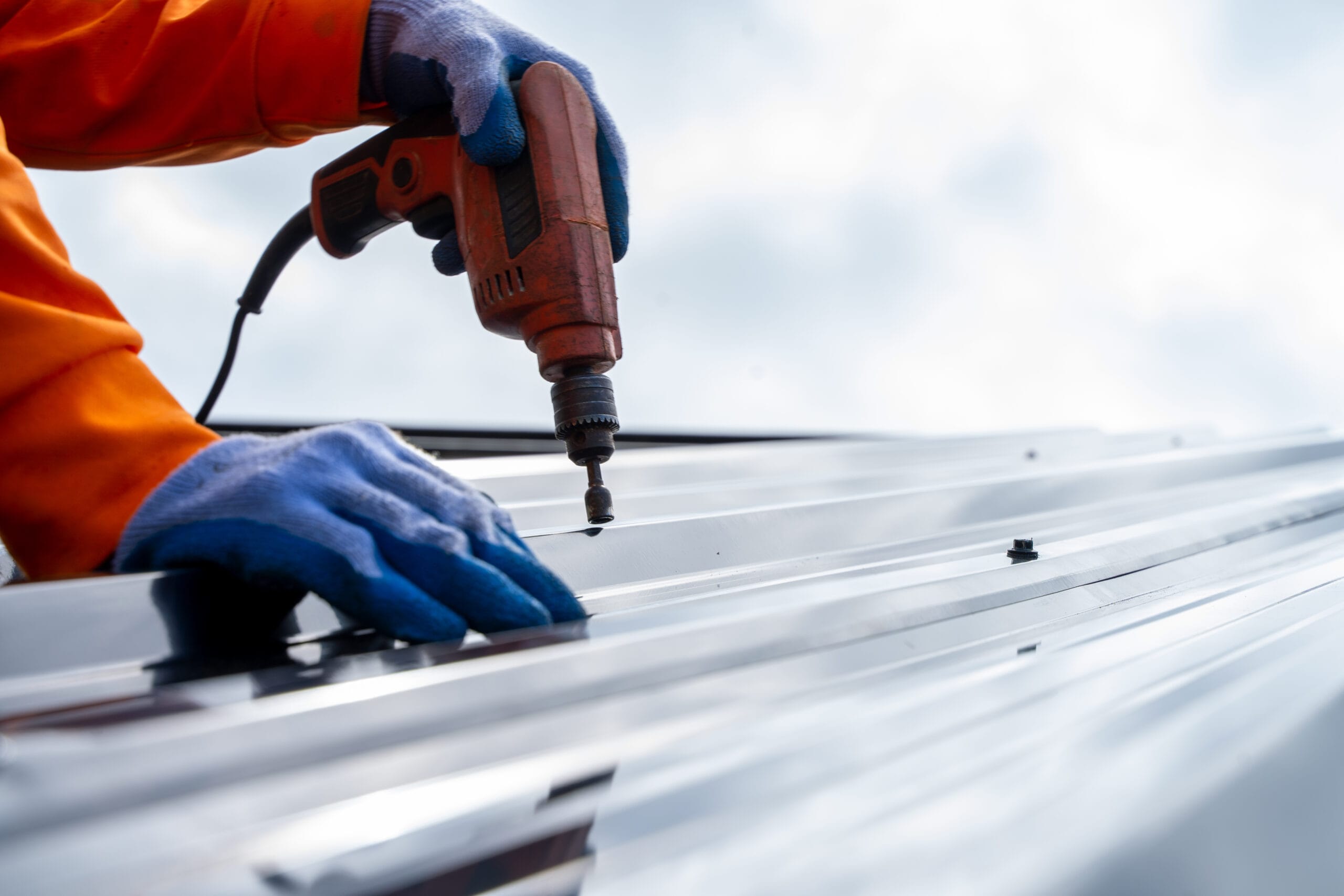 Worker puts roofing material in the open air. Commercial rooring materials.