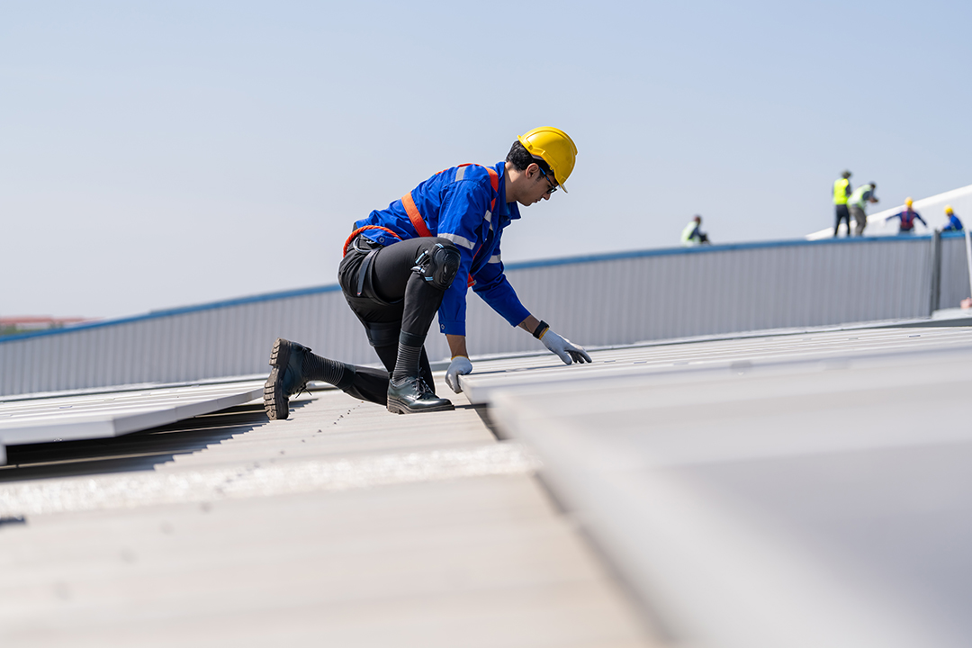 Engineer inspects on the roof of factory. Commercial Roof Maintenance